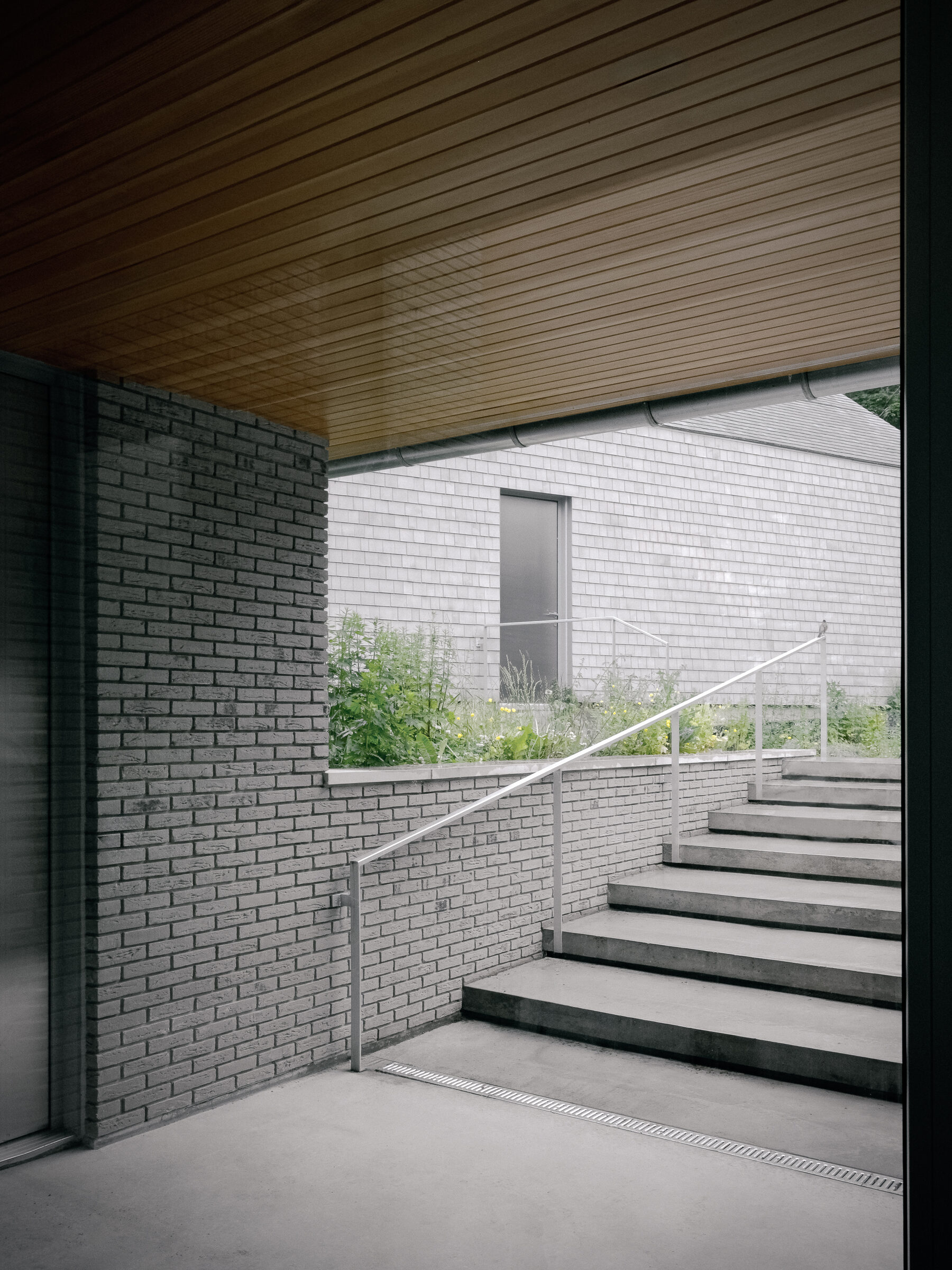 Concrete stair between brick walls