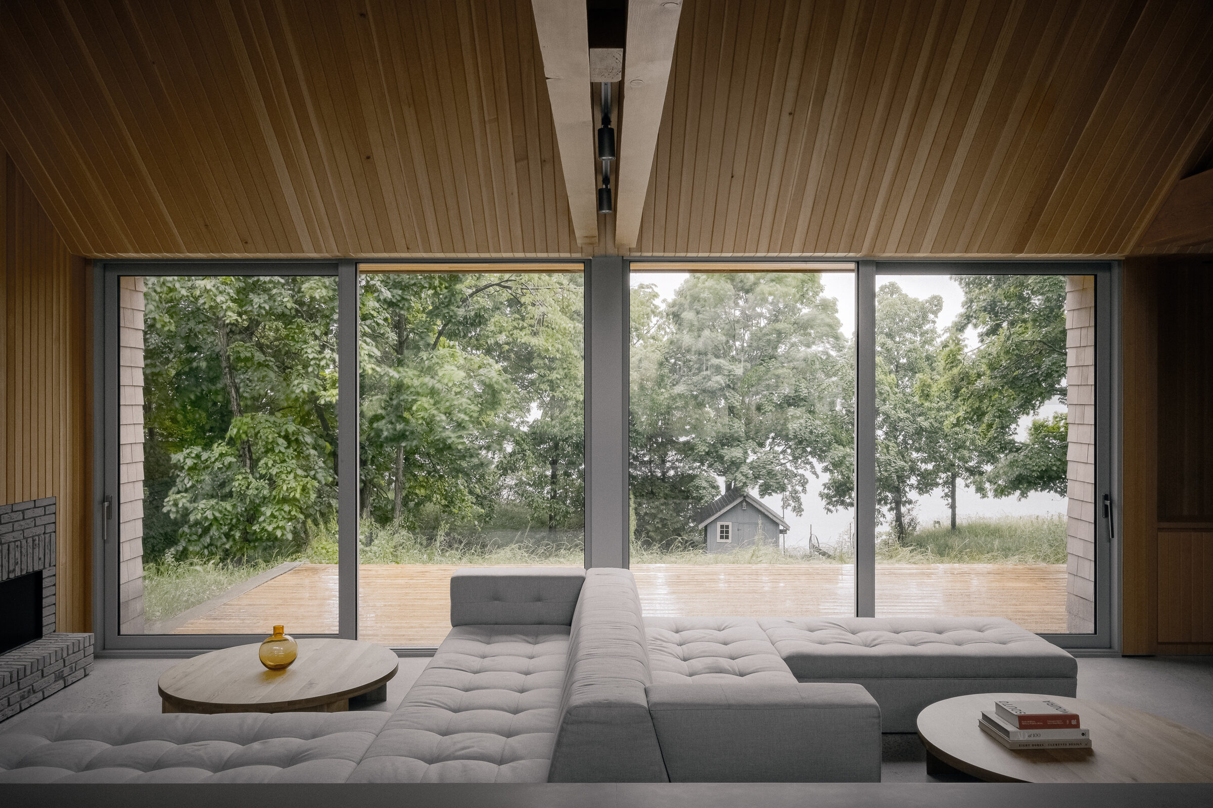 Living room bench seating facing the deck and lake
